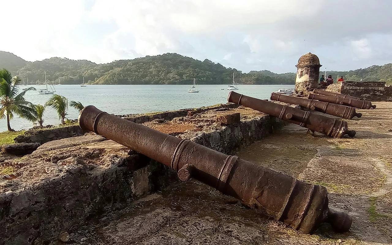 Cannons at Portobello Fort overlooking the bay, part of Isla Mamey Tours in Panama City.