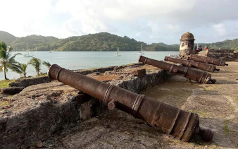 Cannons at Portobello Fort overlooking the bay, part of Isla Mamey Tours in Panama City.