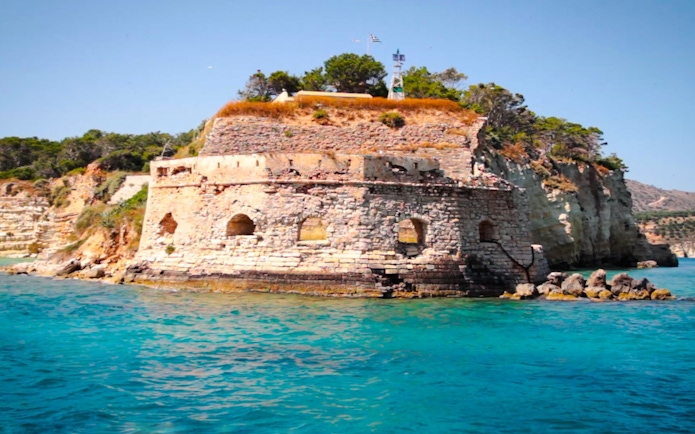 Venetian Fortress of Souda overlooking turquoise sea and rocky coastline.