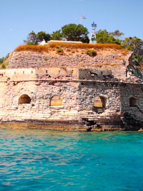 Venetian Fortress of Souda overlooking turquoise sea and rocky coastline.
