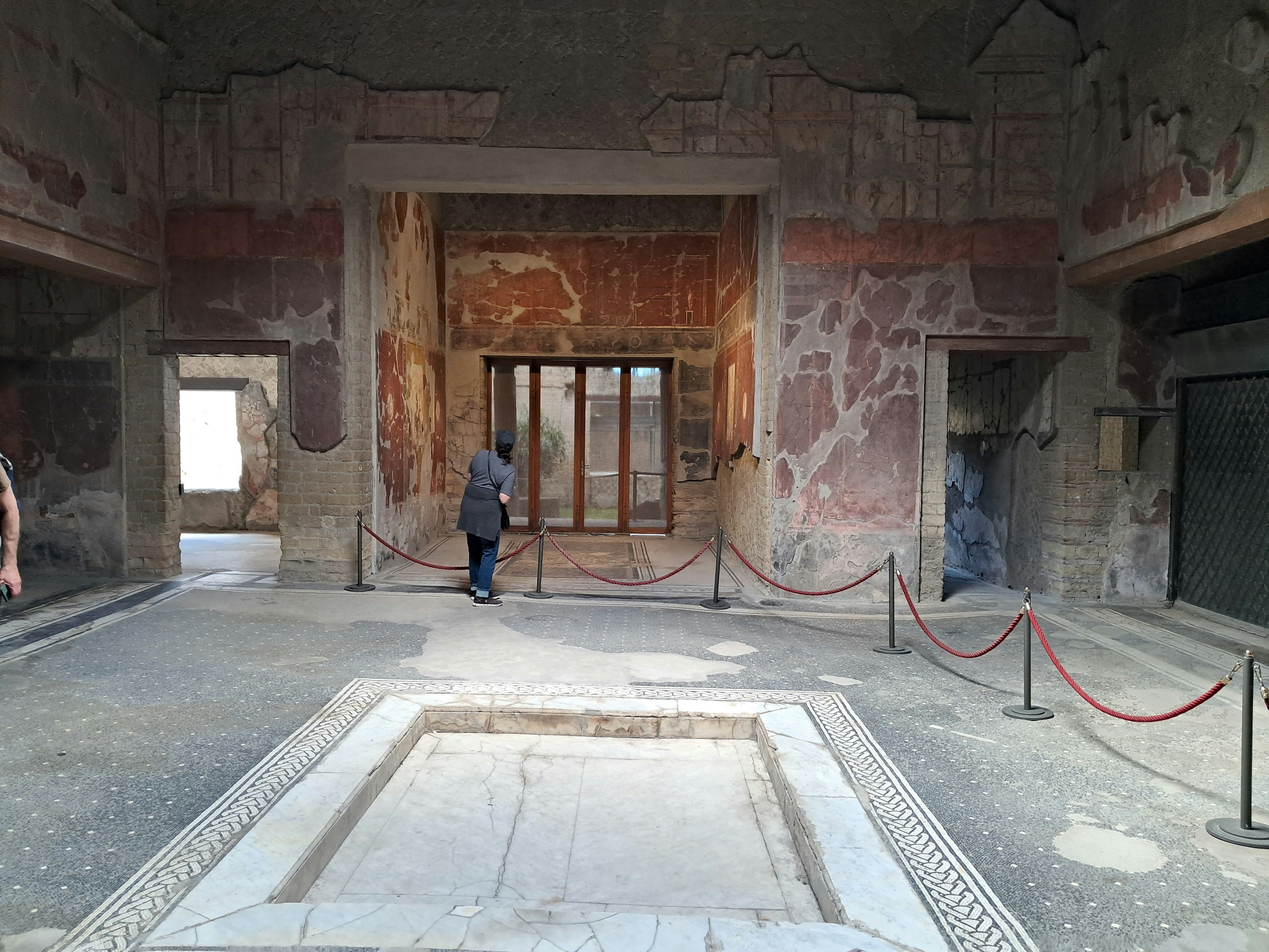 Samnite House interior with ancient frescoes and mosaic floor in Herculaneum, Italy.