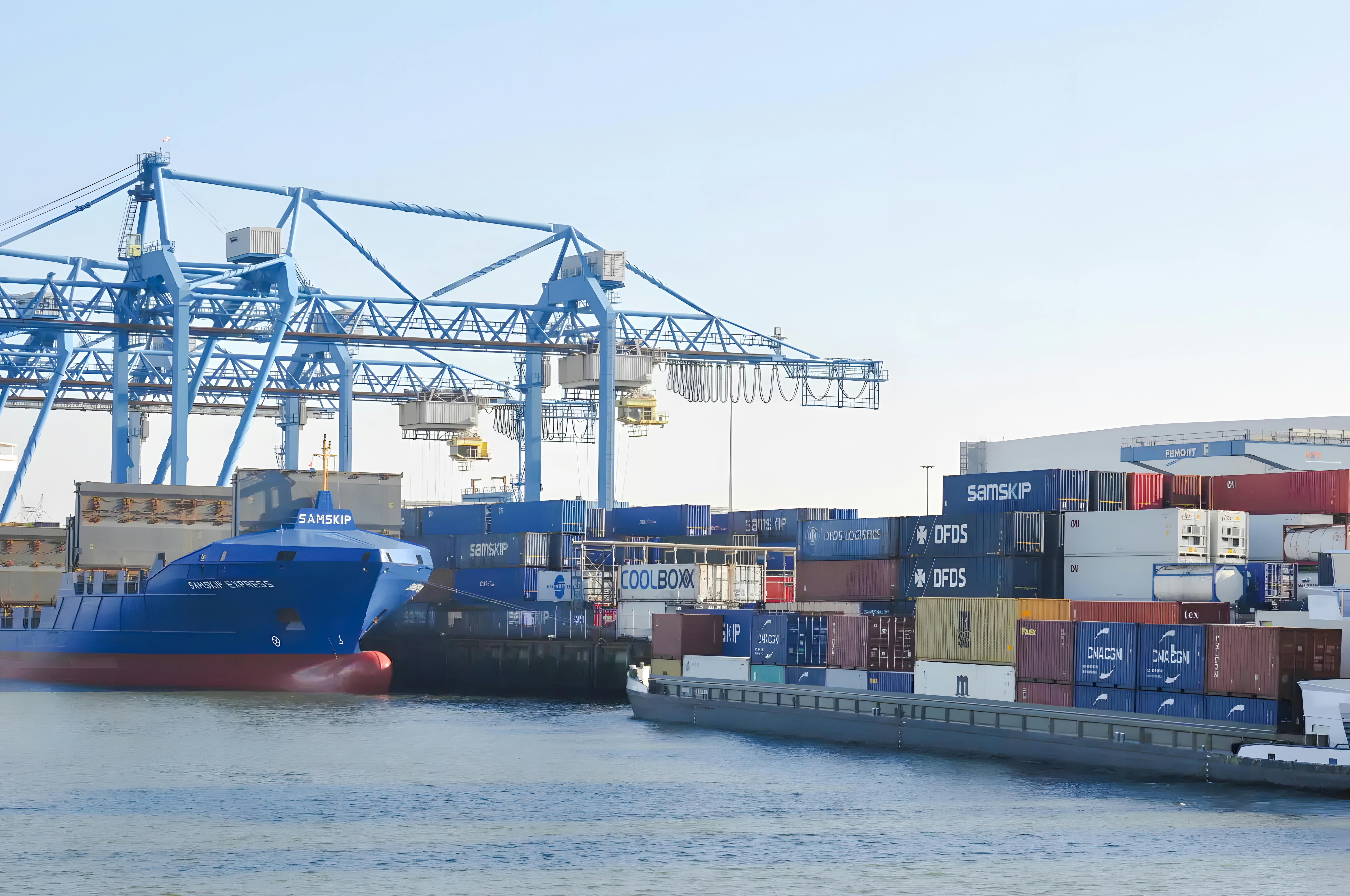 Container ship and cranes at Rotterdam harbor during sightseeing cruise.