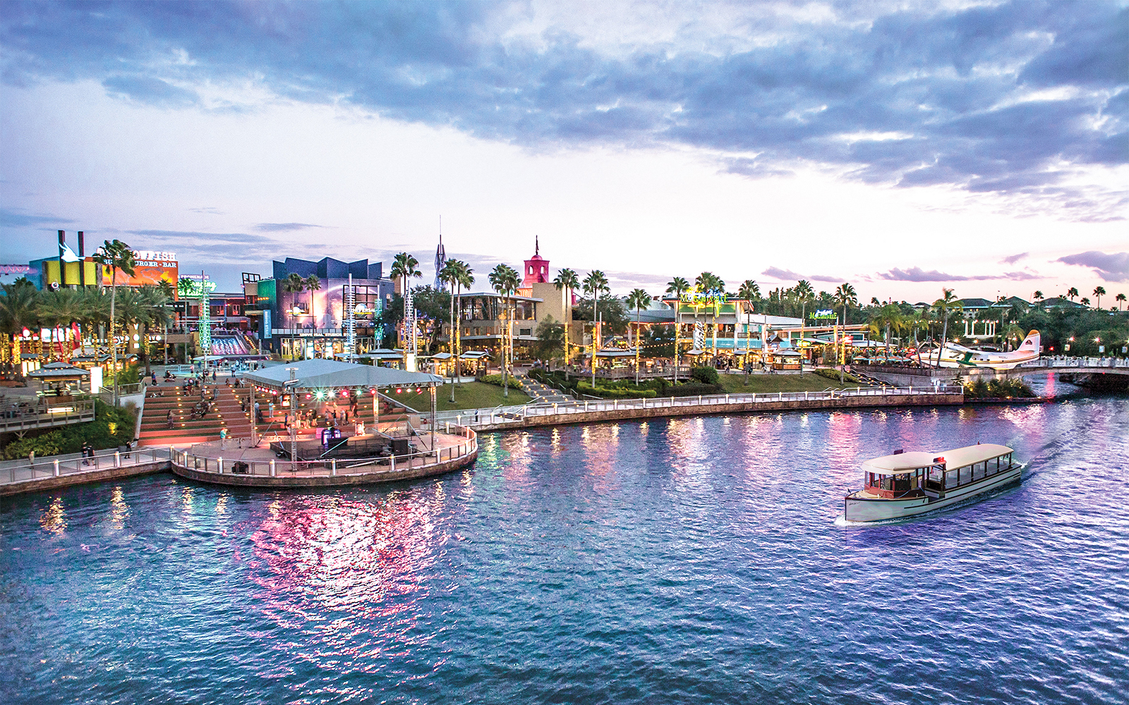 Universal CityWalk Orlando waterfront with boat and vibrant nightlife.