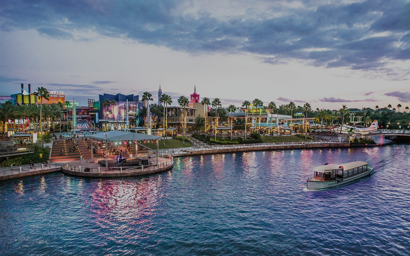 Universal CityWalk Orlando waterfront with boat and vibrant nightlife.