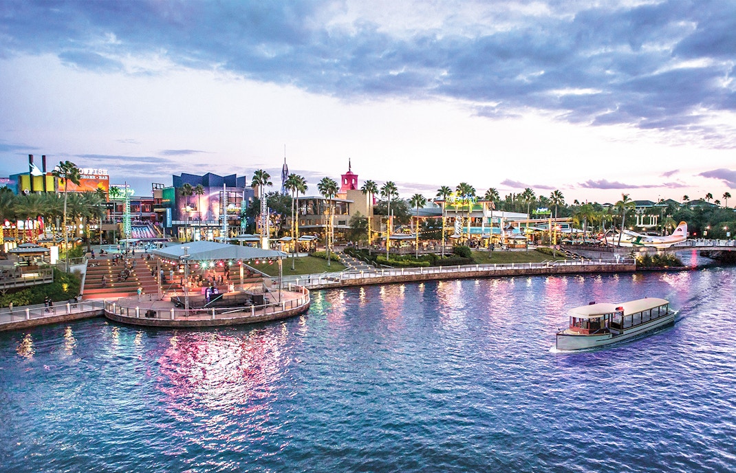 Universal CityWalk Orlando waterfront with boat and vibrant nightlife.