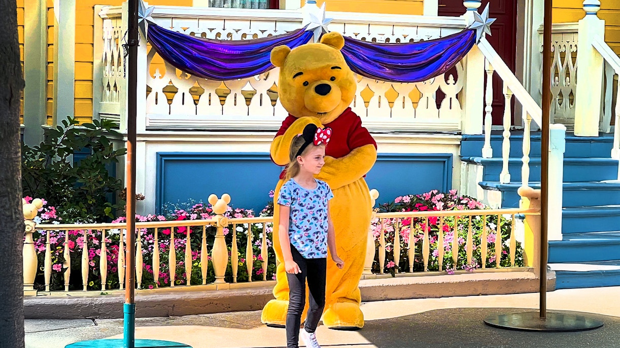 Winnie the Pooh with a child at Disneyland Paris meet and greet.