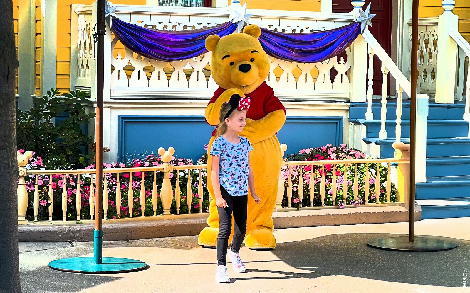 Winnie the Pooh with a child at Disneyland Paris meet and greet.