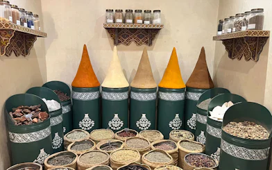 Spices displayed in jars and sacks at Moroccan Culinary Art Museum.