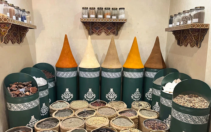 Spices displayed in jars and sacks at Moroccan Culinary Art Museum.