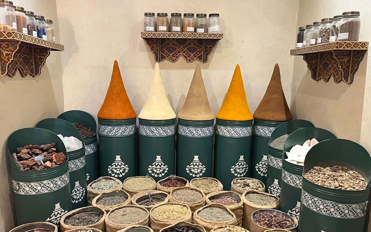 Spices displayed in jars and sacks at Moroccan Culinary Art Museum.