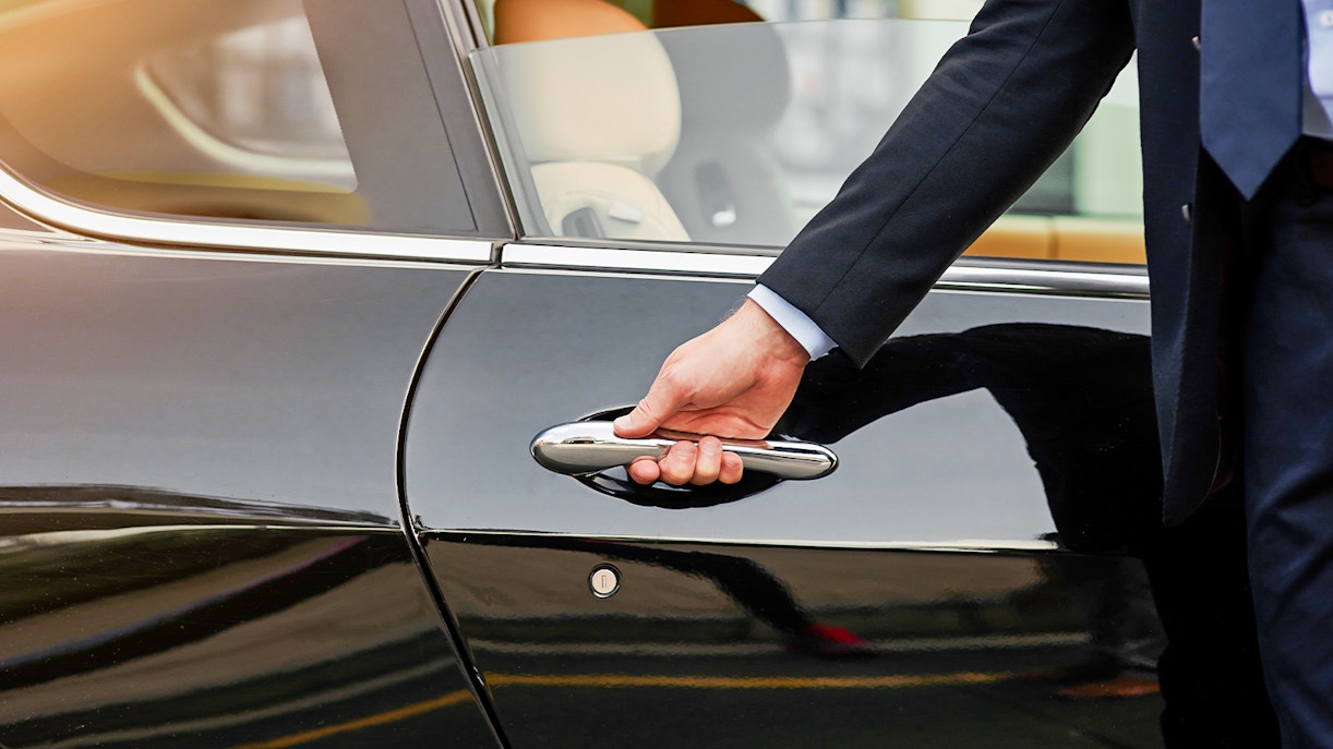Hand opening car door for pick up and drop service
