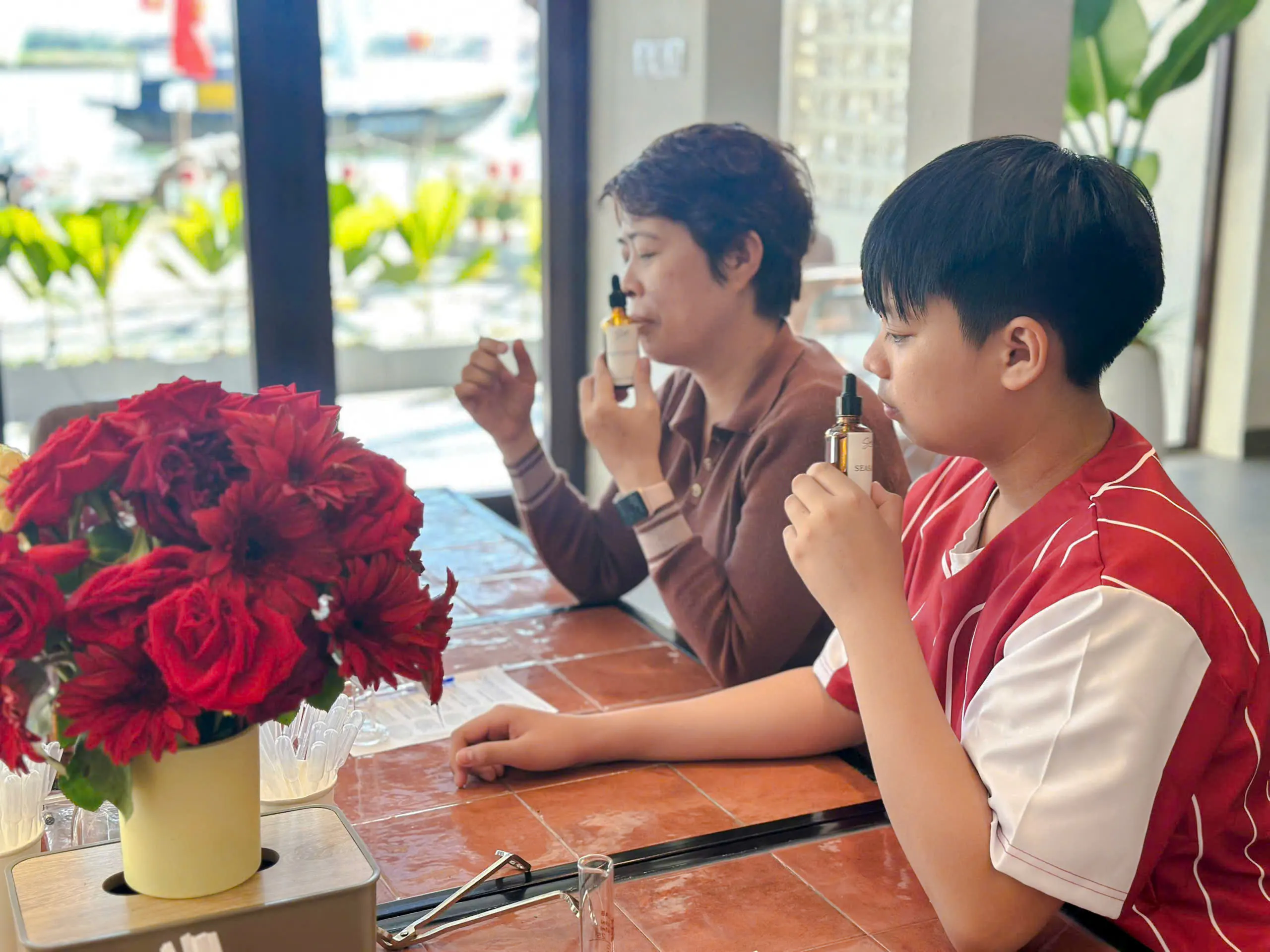 People creating custom scents at a workshop in Hoi An, Da Nang.