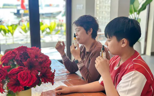 People creating custom scents at a workshop in Hoi An, Da Nang.