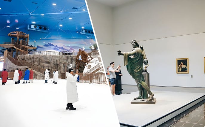 Indoor ski slope with visitors in winter attire; adjacent museum gallery with classical statue.