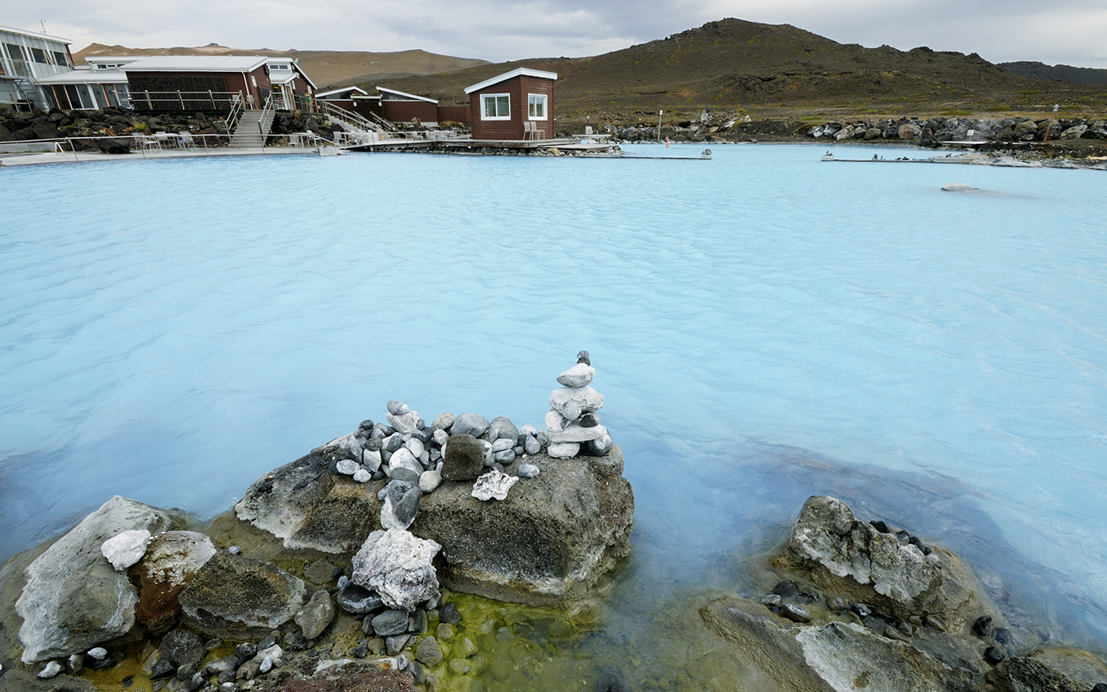 Myvatn Nature Baths with geothermal waters and surrounding rocky landscape.