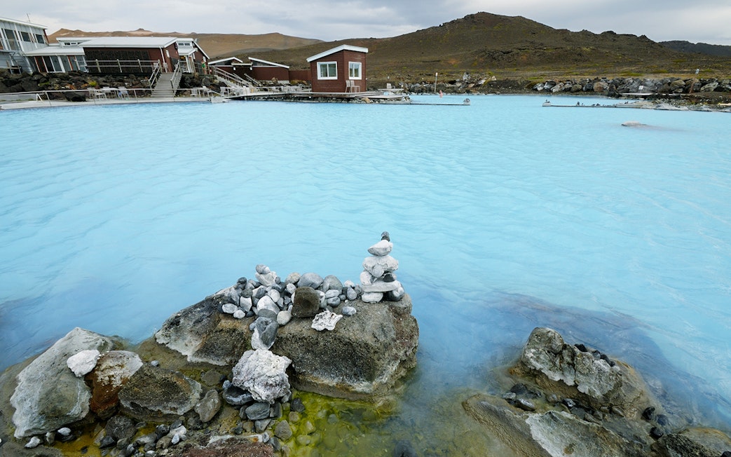Myvatn Nature Baths with geothermal waters and surrounding rocky landscape.