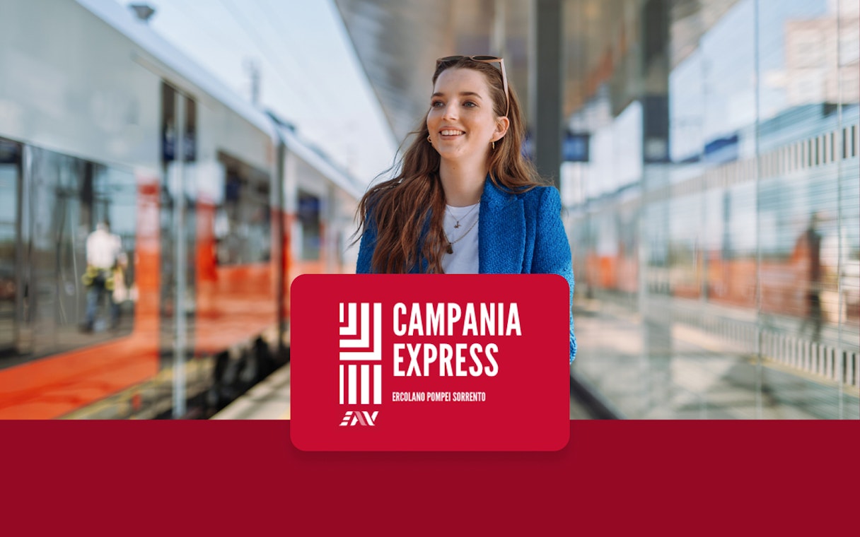 Train platform at Naples Porta Nolana with Campania Express sign.