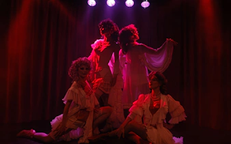 Performers in elegant costumes on stage at Rojo Tango Show, Buenos Aires.