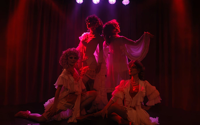 Performers in elegant costumes on stage at Rojo Tango Show, Buenos Aires.