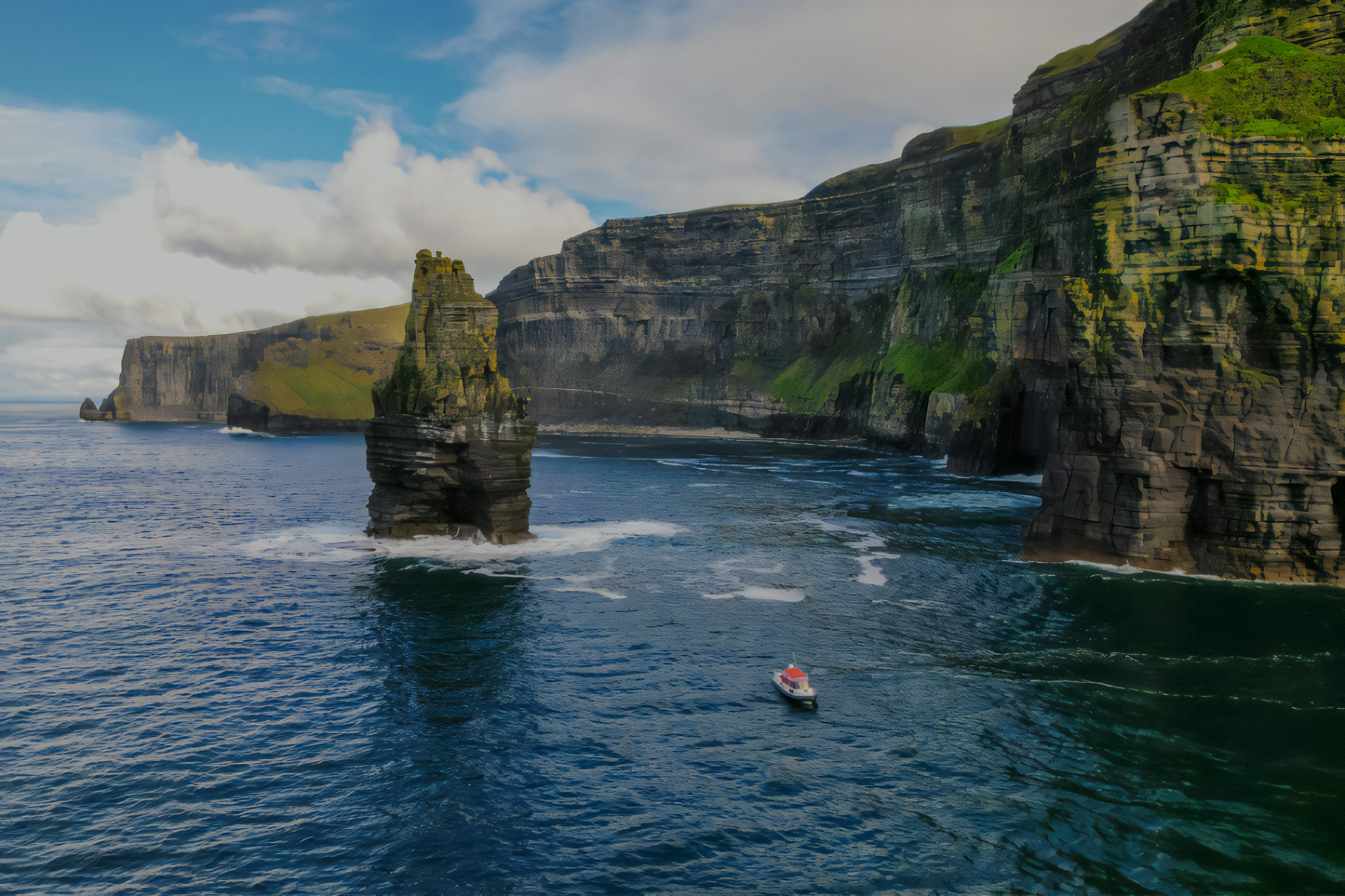 Aerial view of a boat near the Cliffs of Moher, Ireland.
