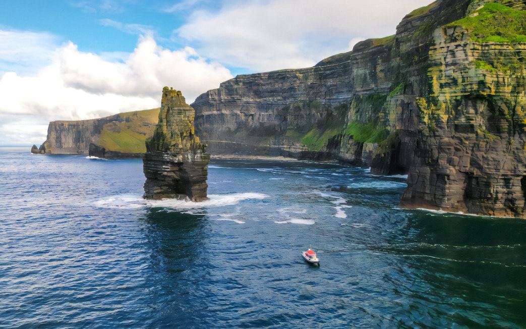 Aerial view of a boat near the Cliffs of Moher, Ireland.