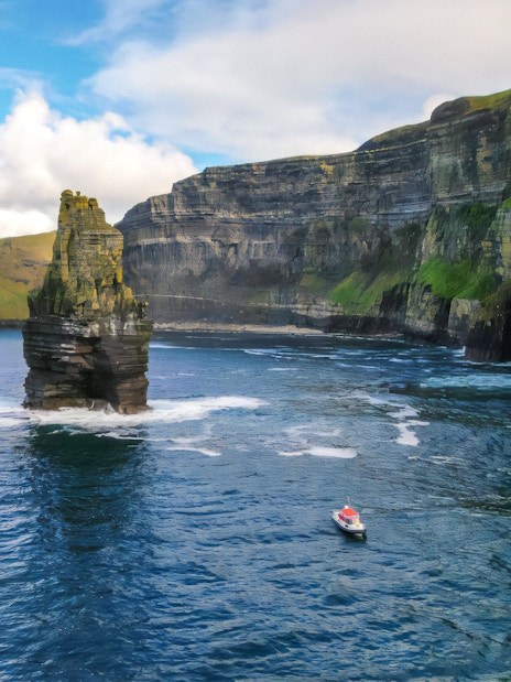 Aerial view of a boat near the Cliffs of Moher, Ireland.