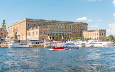 Stockholm hop-on hop-off boat near the Royal Palace on a sunny day.