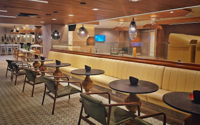Seating area in Mera VIP Lounge at Cancun International Airport with modern decor.