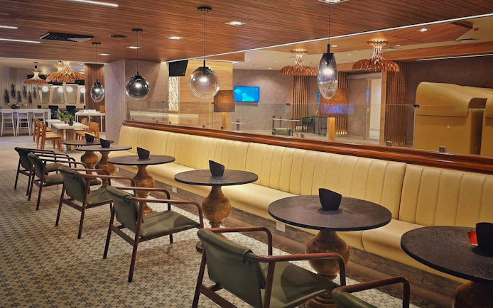 Seating area in Mera VIP Lounge at Cancun International Airport with modern decor.