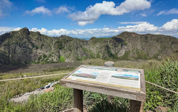 Information board overlooking Mount Vesuvius crater in Italy.