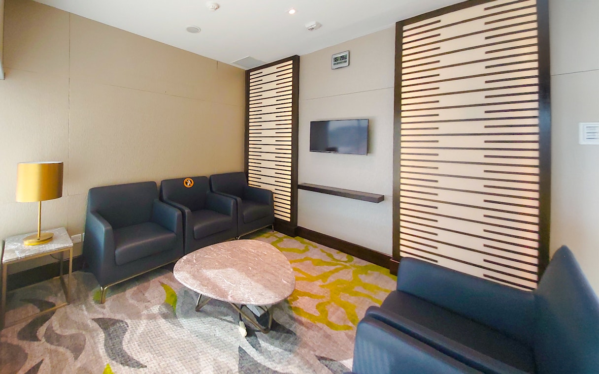 Meeting room with seating and TV, Ambassador Transit Lounge Terminal 3, Changi Airport.
