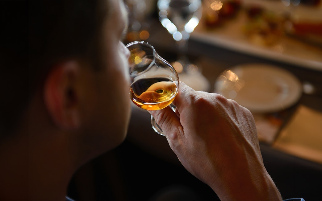 Guest sampling whiskey during Edinburgh Whiskey Tasting Tour.