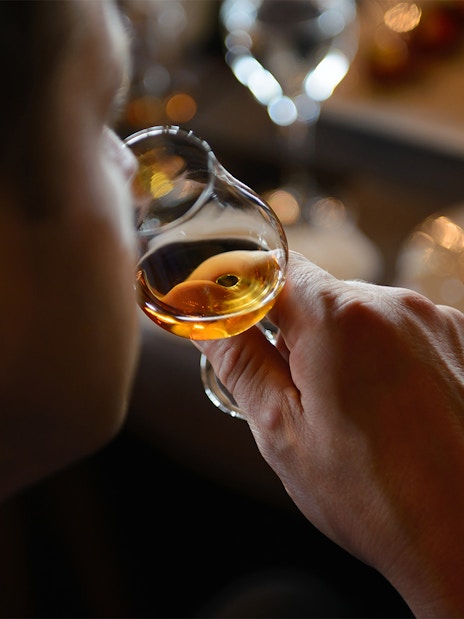 Guest sampling whiskey during Edinburgh Whiskey Tasting Tour.