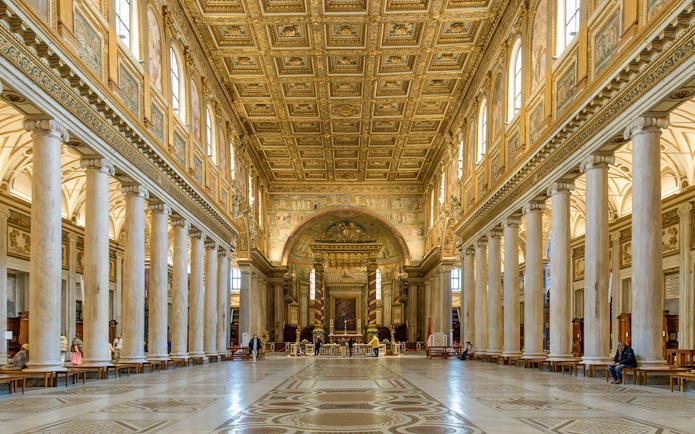 Interior of a Roman basilica with ornate ceiling and columns on the Appian Way tour.