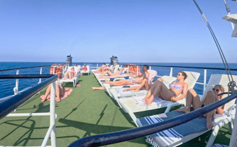 People sunbathing on a cruise deck during the Blue Lagoon cruise from Larnaca.