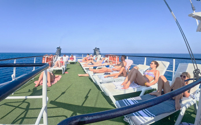 People sunbathing on a cruise deck during the Blue Lagoon cruise from Larnaca.