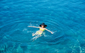 Person swimming in the Bosphorus during an Istanbul group cruise.