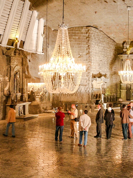 Visitors exploring the ornate chapel inside Wieliczka Salt Mine on a guided tour.