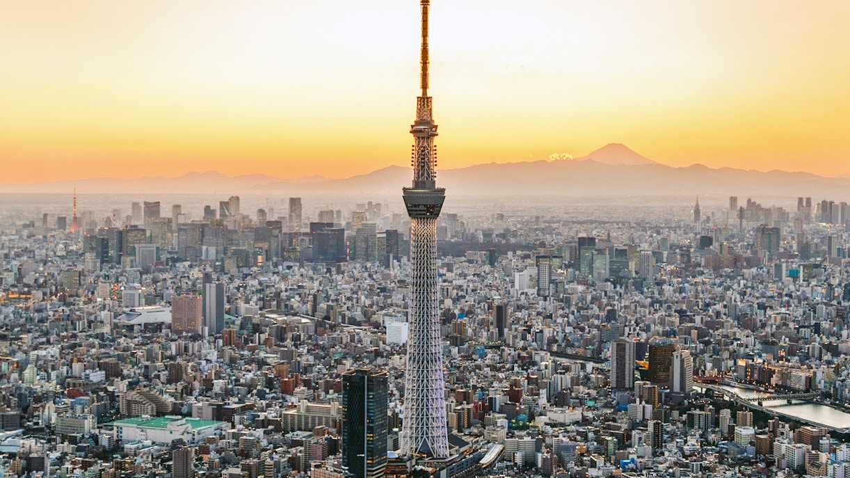 Tokyo Skytree towering over cityscape with clear blue sky in Tokyo, Japan.