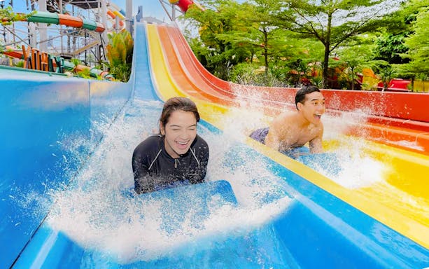 Tourists enjoying water rides at Ancol Atlantis Water Adventure Park, Jakarta.