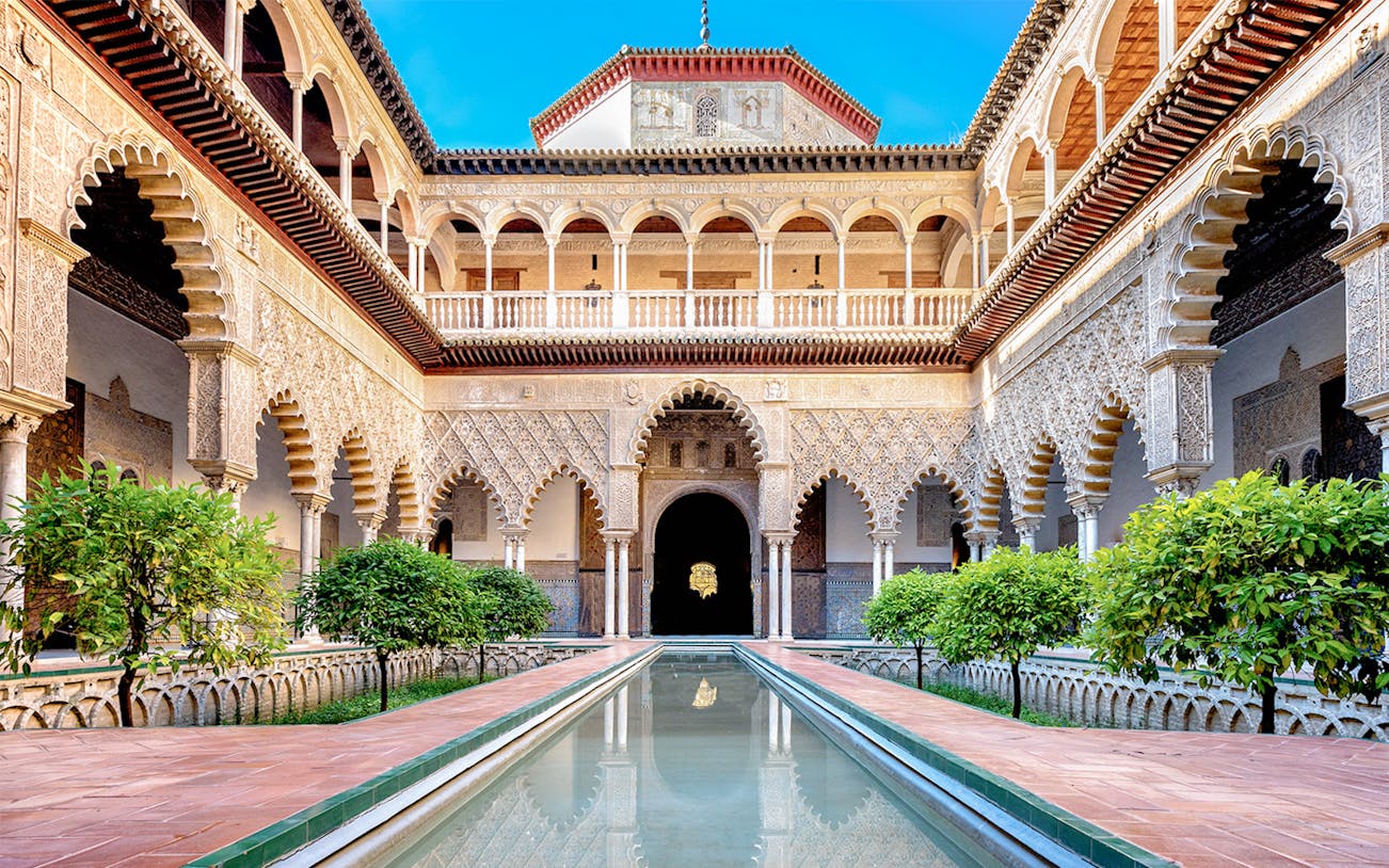 Patio de las Doncellas courtyard with reflecting pool, Real Alcazar, Seville.