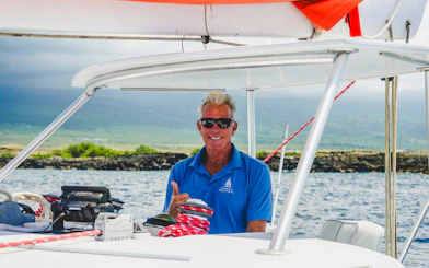 Tour guide on a boat during Kona Deluxe Whale Watch Sail in Hawaii.