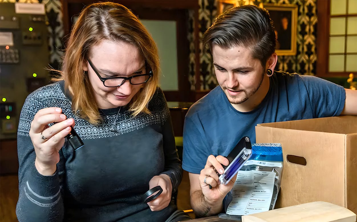 Participants solving clues in a Sherlock Holmes-themed escape room experience.