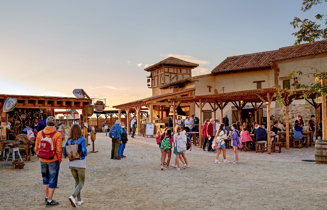 Visitors exploring historical reenactment at Puy du Fou España park, Toledo, Spain.