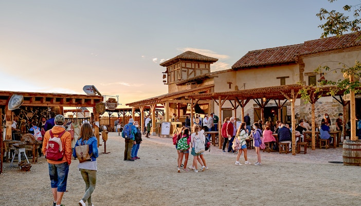 Visitors exploring historical reenactment at Puy du Fou España park, Toledo, Spain.