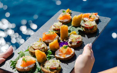 Assorted appetizers on a slate platter during Athens day cruise lunch.
