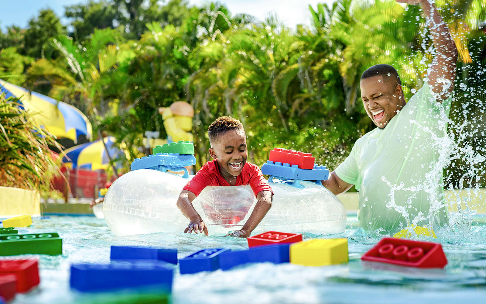 Child enjoying Lazy River at Legoland Florida Water Park with colorful Lego floats.