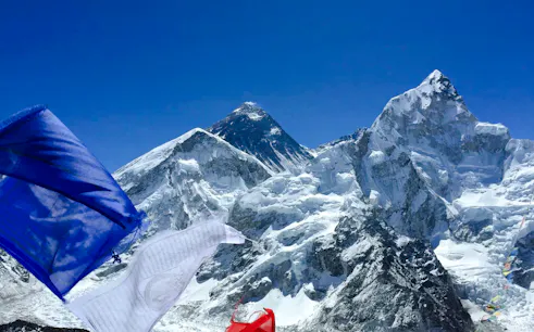 Prayer flags with Mount Everest in the background, Everest Region helicopter tour.