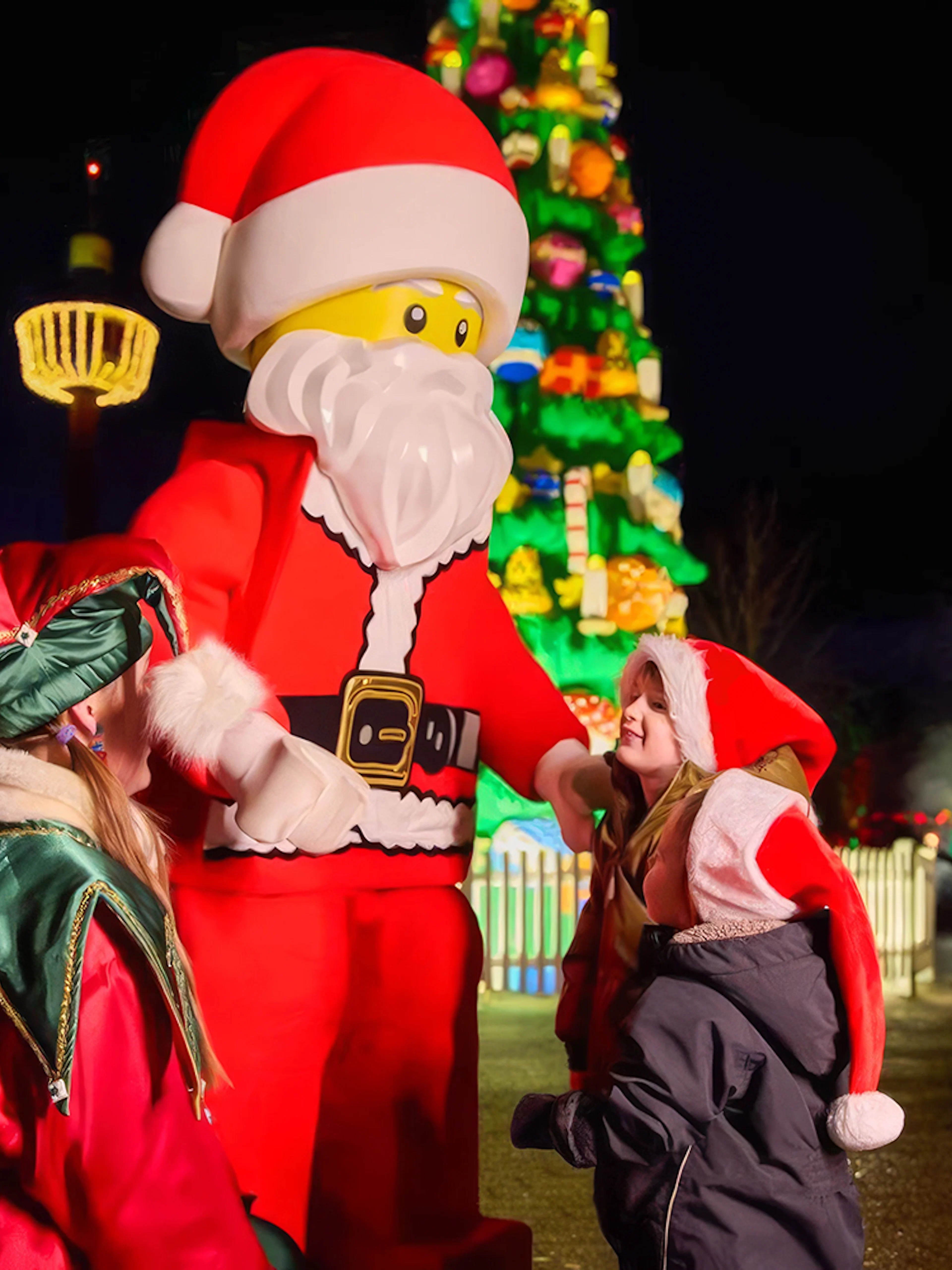 Santa LEGO figure with children at LEGOLAND® Billund Christmas event.