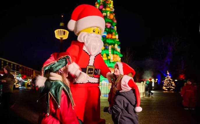 Santa LEGO figure with children at LEGOLAND® Billund Christmas event.